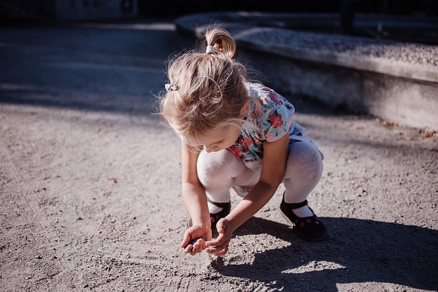 Little girl playing in crouched position